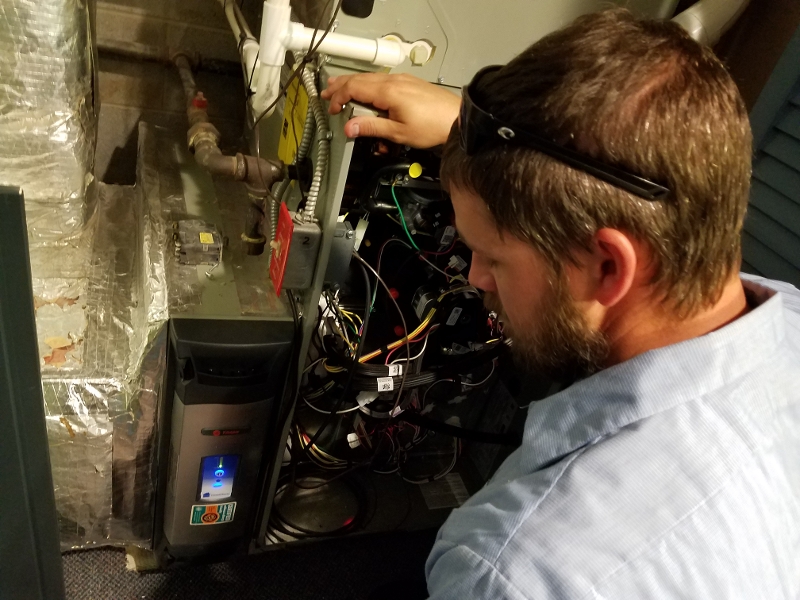 technician servicing a high efficiency air purifier